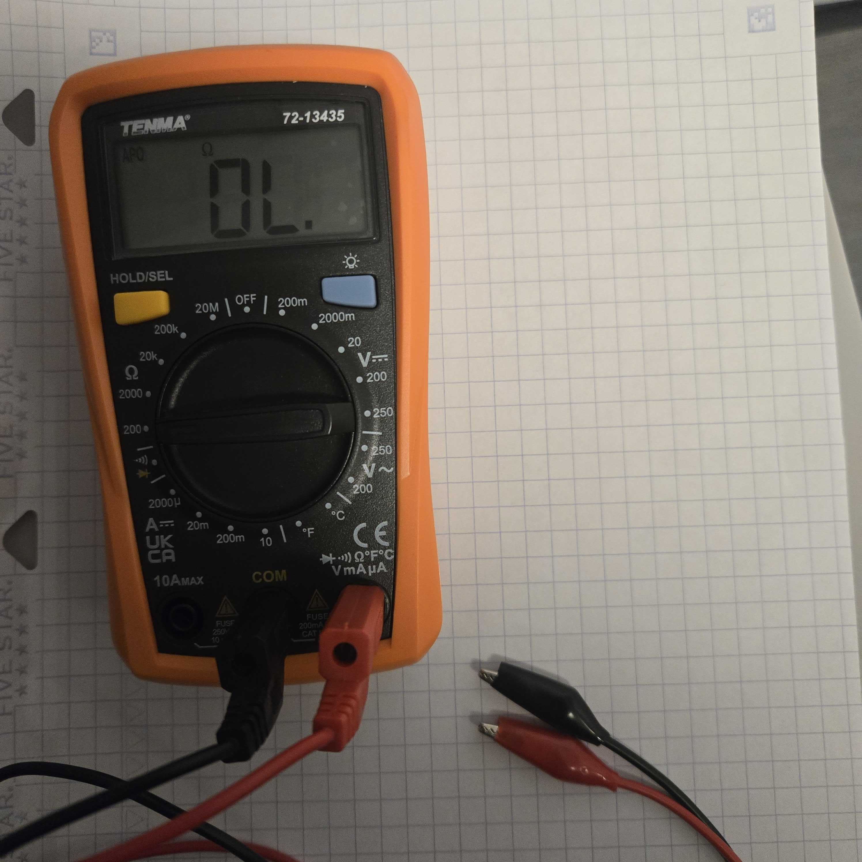 Multimeter with probes in correct configuration, and set to measure at 200 Ohms and below