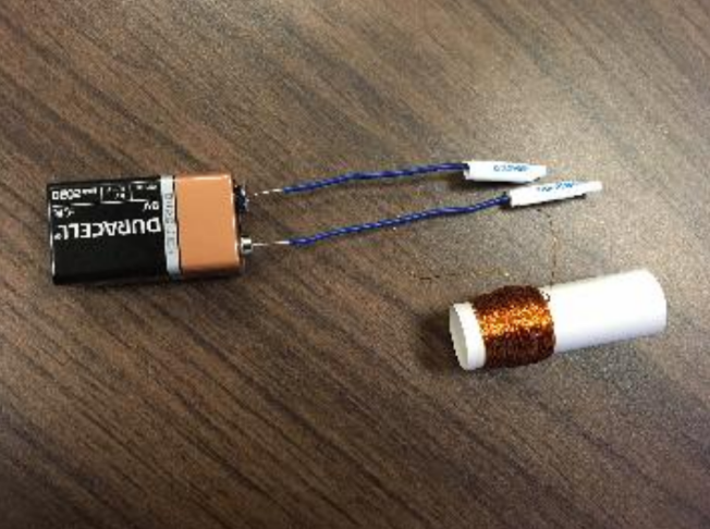 Testing the solenoid by temporarily connecting the wires to the terminals of a 9V battery